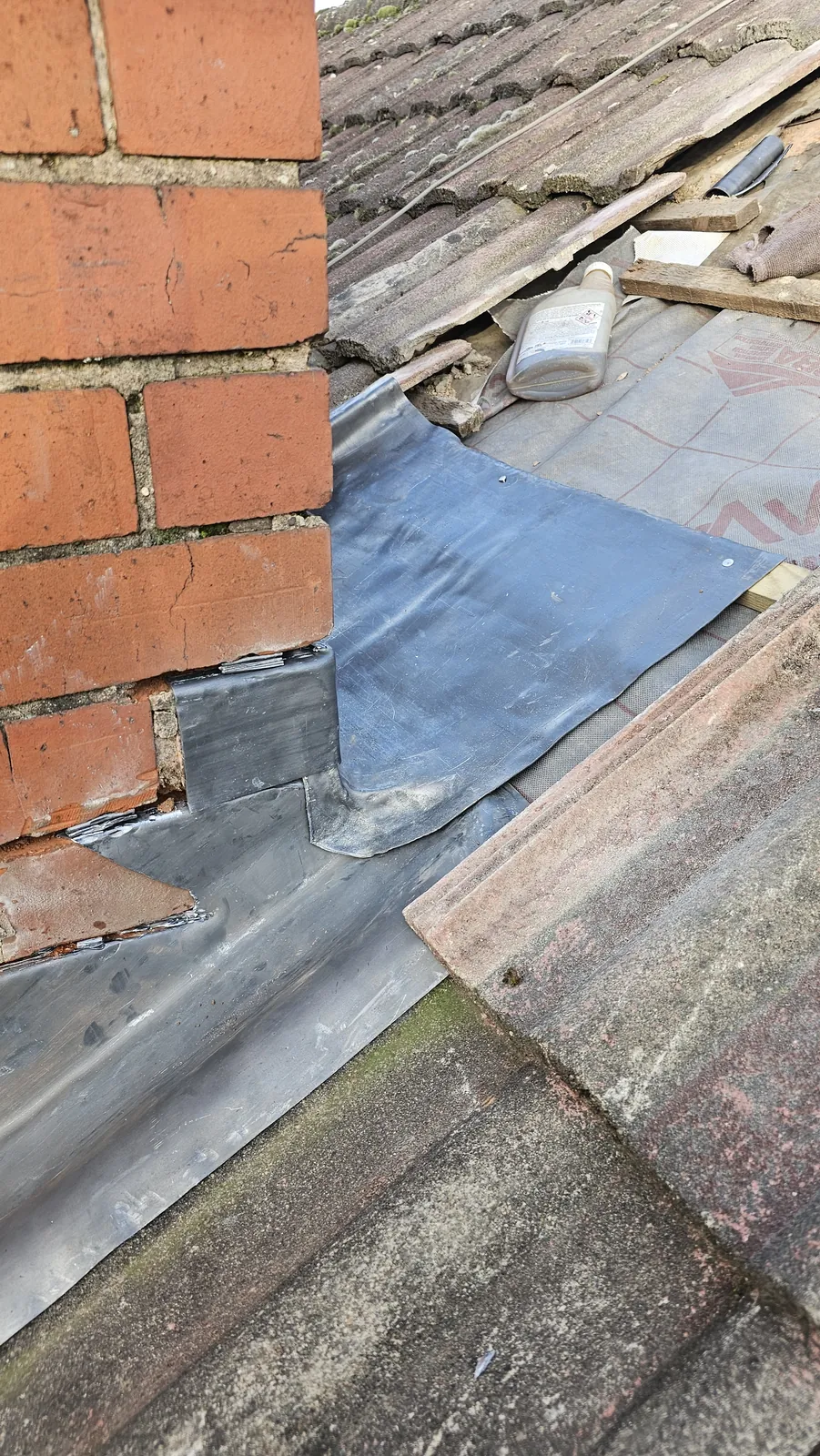 Lead soakers between tiles