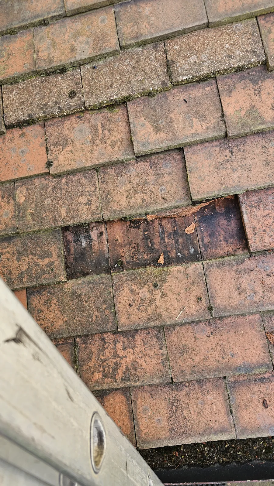 Slipped tiles being replaced